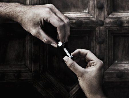 The perfect combination. Cropped image of two hands screwing together a nut and bolt.の写真素材