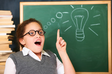 I know what to do. A cute brunette girl getting a sudden idea in class.