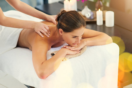 Spa day is my favorite day of the week. a beautiful young woman lying on a massage table at the day spa.の写真素材