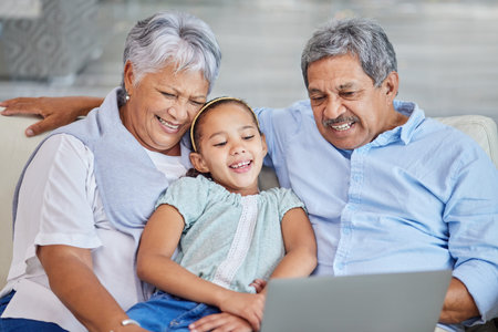 Closeup of an affectionate mixed race senior couple relaxing in their living room with their...