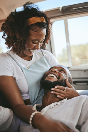 Black couple, smile and laugh for love in road trip adventure, travel and relaxing together. African American man and woman in loving, caring and embracing relationship for traveling in natureの写真素材