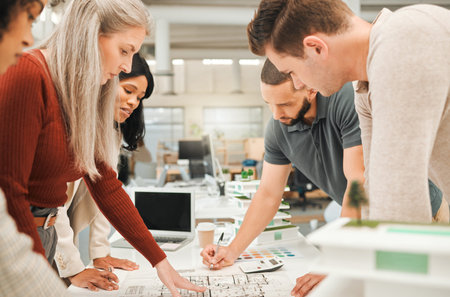 Group of engineers looking at a blueprint. Architects in a business meeting. Businesspeople...