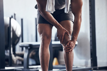Knee, legs and joint pain of gym man, athlete and training, workout or exercise in fitness club....