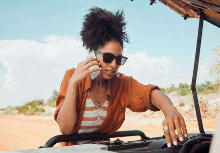 Phone, call and road trip with a woman in need of roadside assistance after vehicle breakdown while on vacation. Car, travel and communication with a young female calling for help during an emergencyの写真素材