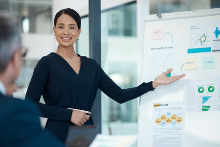 Presentation, marketing and graphs on whiteboard with woman in meeting explaining data statistics in office. Presenter, leader and finance, advertising or sales growth analytics, analysis or info.の写真素材