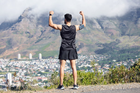 A man celebrate fitness run, training and cardio endurance workout on outdoor nature path for marathon. Sports runner, cheering after finishing running exercise and healthy wellness lifestyle successの写真素材