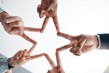 Support, community and peace sign with hands of business people in collaboration for networking, mission and vision. Goals, teamwork and innovation with star and fingers of employee for partnershipの写真素材