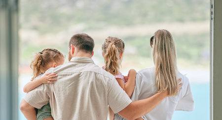 Beautiful people and beautiful views. an unrecognizable family admiring the view from their balcony at home.の写真素材