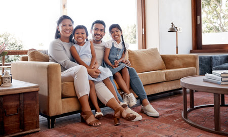 The weekend is family time. Full length portrait of an affectionate young family of four sitting in...