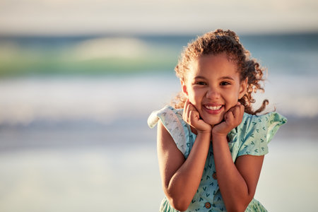 The beach excites me. an adorable little girl having fun at the beach.の写真素材