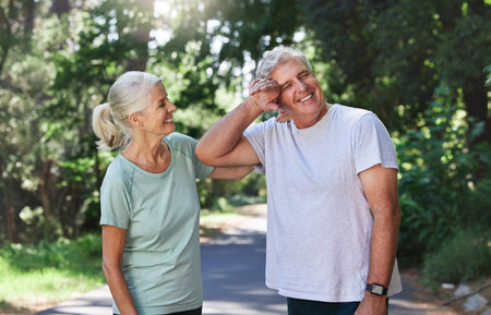 That was tough but we enjoyed it. a mature couple taking a break while exercising outdoors.の写真素材