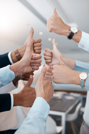 Thumbs up, business people success and hands in modern office of teamwork celebration, review and motivation. Closeup corporate group of winner employees, support and like emoji vote of goal feedbackの写真素材