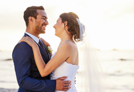 This day is even more beautiful than I though itd be. a young couple on the beach on their wedding day.の写真素材