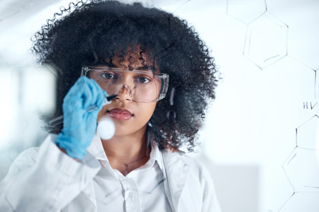 Focused young scientist brainstorming, thinking of ideas in the lab. Young chemist working on her...
