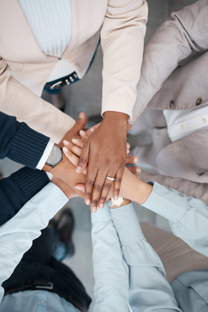 Hands, collaboration and solidarity with a team of business people standing in a huddle or circle in...