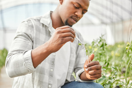 Taking a sample. a handsome young man working on his farm.の写真素材
