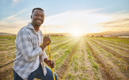 Hes connected to everything green. a farmer standing on a field.の写真素材