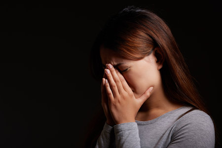 Its the screams for me. a young woman experiencing mental illness against a black background.の写真素材