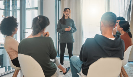 Everyone gets a turn to share their story. a young woman talking during a group therapy session.の写真素材