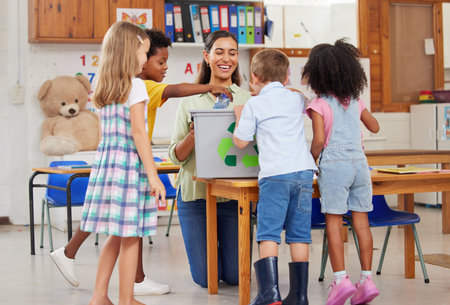 Their education fuels them with curiosity to explore. a young woman teaching a class of preschool children.の写真素材