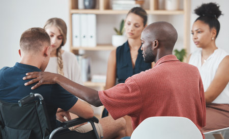 Group counseling, mental health therapy and anxiety wellness conversation for problem of a disabled man. Community support, empathy and compassion for employee burnout or stress in a business officeの写真素材