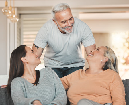 Home is where you are loved. a woman sitting on a couch with her parent.の写真素材