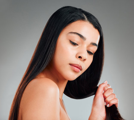 Im a strong woman with strong strands. Studio shot of a beautiful young woman with long brown hair.の写真素材