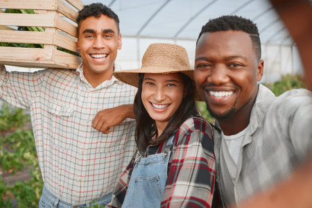 Our love for nature is true. Portrait of a group of people taking selfies while working together on a farm.の写真素材