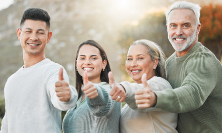 This smile is brought to you by family love. a family showing thumbs up outside.