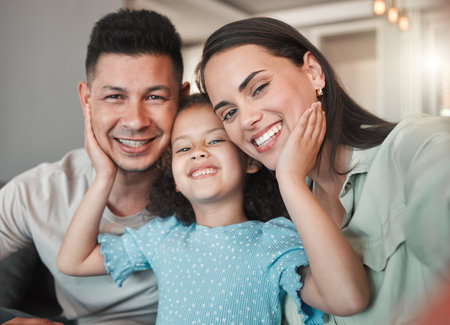 One happy little family. a young family taking a selfie together at home.の写真素材