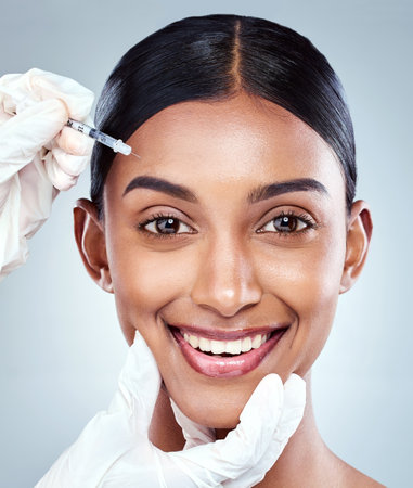 Theres always room for improvement. Cropped portrait of an attractive young woman posing in studio against a grey background.の写真素材