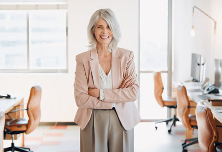 Welcome to my successful startup. a mature businesswoman standing alone in the office with her arms...