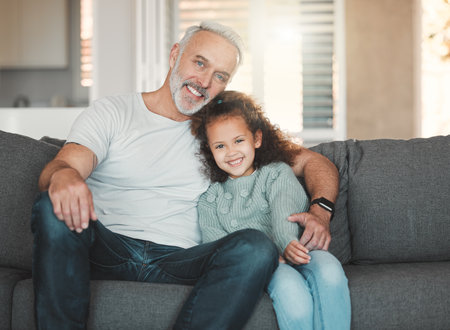 They are Gods gift to you. a girl sitting at home with her grandfather.の写真素材