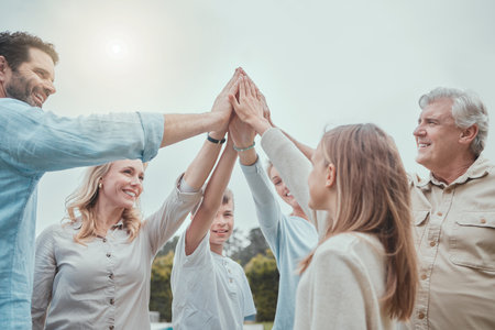 We support each other to the end. a family giving each other a high five in the garden at home.の写真素材