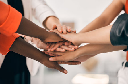 Our motivation comes from one another. a group of unrecognizable businesspeople stacking their hands...