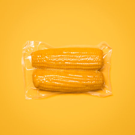 Packed full of sweetness. a package of corn against a studio background.の写真素材