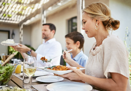 Sitting down to enjoy a meal together. a family enjoying a meal together.の写真素材