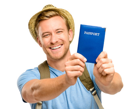 Look what I got. a handsome young tourist standing alone in the studio and holding his passport.の写真素材