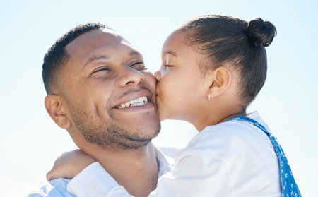 Captain on her little heart. an adorable little girl and her father bonding outside.の写真素材
