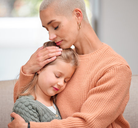 Moms got you. a young mother comforting her daughter on the sofa at home.の写真素材
