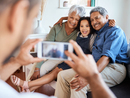 She loves time with her grandparents. a photo being taken of a grandchild with her grandparents at...