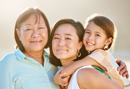 Every girl needs strong women in her life. Cropped portrait of an attractive young woman on the beach with her mother and daughter.の写真素材