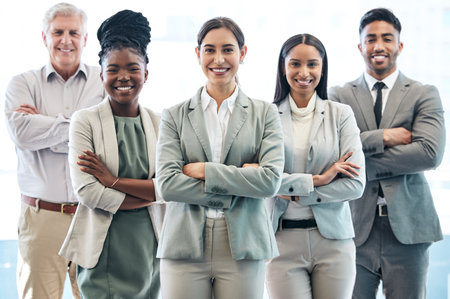 Confidence is a wonderful thing. Cropped portrait of a diverse group of corporate businesspeople standing with their arms folded in the office.の写真素材