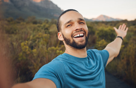 Happy, nature and man taking a selfie in the countryside for a peaceful holiday adventure outdoors in spring with freedom. Smile, pictures and man enjoying traveling and quality vacation time aloneの写真素材