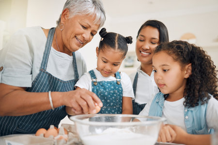 This is how we crack the egg. a multi-generational family baking together at home.の写真素材