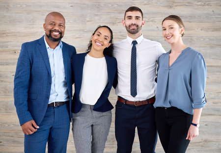 They make the job worthwhile. a group of businesspeople standing in an office at work.の写真素材