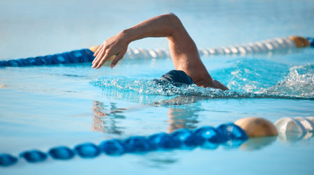 Competing against himself. an unrecognizable young male athlete swimming in an olympic-sized pool.の写真素材