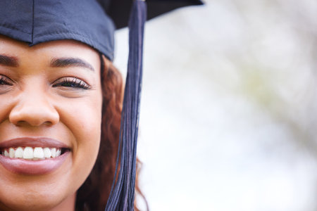 The tassel was worth the hassle. Portrait of a young woman on graduation day.の写真素材