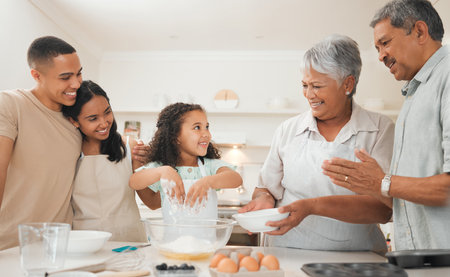 Always nurture talent at a young age. three generations of a family baking together.の写真素材