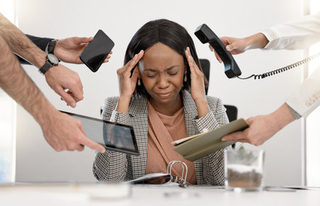 The pressure is getting the best of her. a young businesswoman feeling stressed out in a demanding office environment.の写真素材